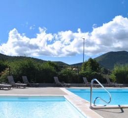 Swimming pool overlooking the village of Montbrun at the Le Hameau des Sources residence