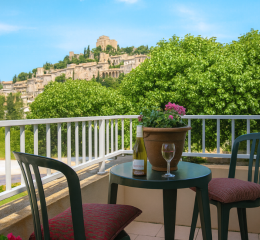 Glass terrace at Le Hameau des Sources in Montbrun-les-Bains with a view of the village
