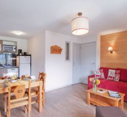 Living room with sofa and dining table in an apartment at the Ours Blanc residence