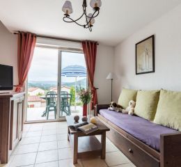 Living room in the cottages at the Domaine des Cazlles in Cajarc with terrace view