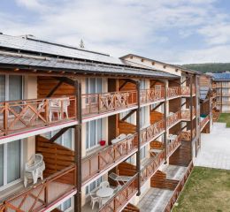Exterior of the Pyrénées 2000 residence with a close-up of the balconies in summer