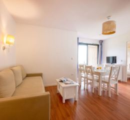 Living room with dining area in one of the Fleur de Sel residence's accommodation units in Guidel