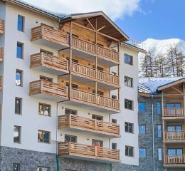 Exterior façade covered in snow at the Arya Living Stone residence in Vars