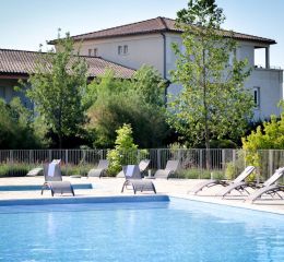 Outdoor swimming pool surrounded by vineyards at the Château de Jouarres residence in Azille