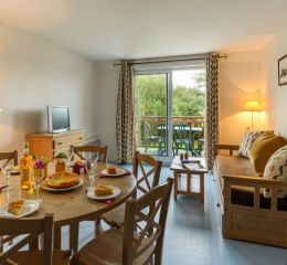 Séjour avec espace salle à manger et salon au sein d’un appartement de la résidence Les Roches Douvres