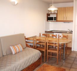 Living room of an apartment at the Soko Eder residence with sofa bed and dining area