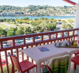 Balcony with outdoor seating overlooking the port from an apartment in the Sokoburu residence