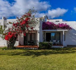 Exterior of a villa at Pedras del Rei in Portugal, featuring surrounding vegetation and a private outdoor terrace