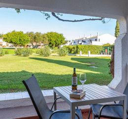Covered terrace of a white villa in the Pedras da Rainha residence, Portugal