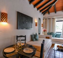 Dining and living area in a villa within the Pedras da Rainha residence, Portugal