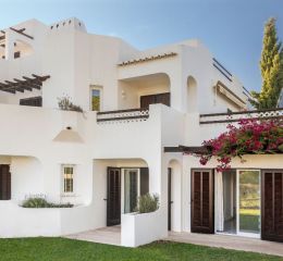 White stone apartments surrounded by flowers at Balaia Golf Village in the Algarve