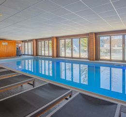 Piscine intérieure chauffée avec transats et vue sur les montagnes de Flaine à la résidence Les Terrasses de Veret