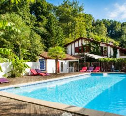 Swimming pool with colourful sun loungers at Les Collines Iduki residence
