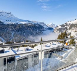 Snow-covered balcony with a view of the mountains at the Les Terrasses de Veret residence