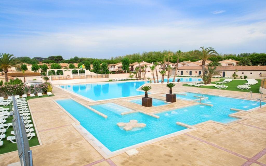 Slide Large swimming pool with sun loungers at the Résidence Les Tamaris & Les Portes du Soleil