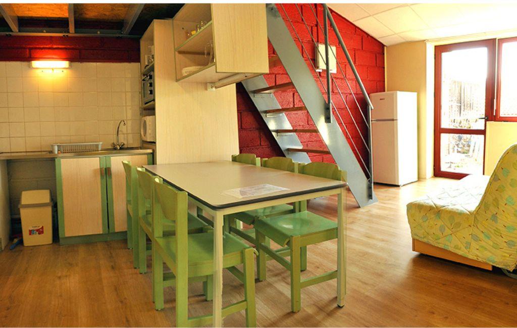 Slide Dining area in a cottage at Résidence Vorey-sur-Arzon with open-plan kitchen