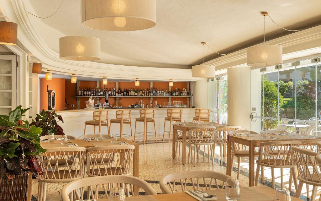 Slide Indoor dining area near the pool at Balaia Golf Village